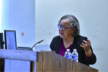 Barbara Savage speaking at a podium